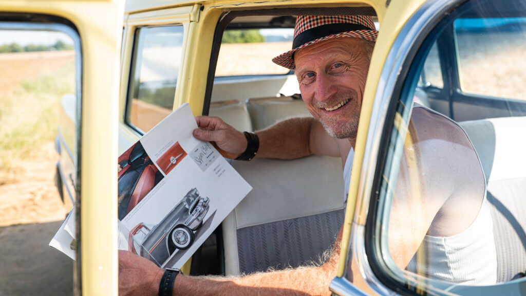 Mann sitzt in gelbem Pontiac Oldtimer